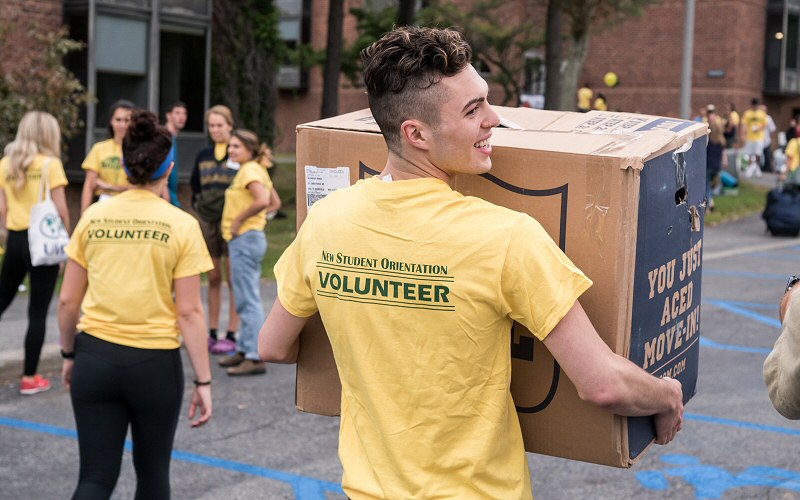 Student-athletes and other volunteers help classmates unload and move in to their new home away from home