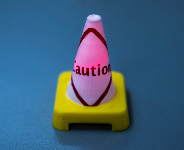 a battery operated miniature construction cone is shown during an open house at The Hub