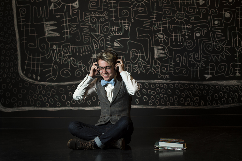 Student sitting on the floor with headphones