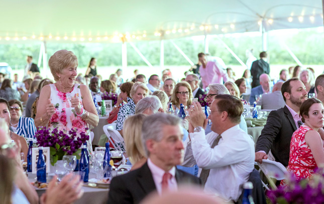 People under at tent at a party