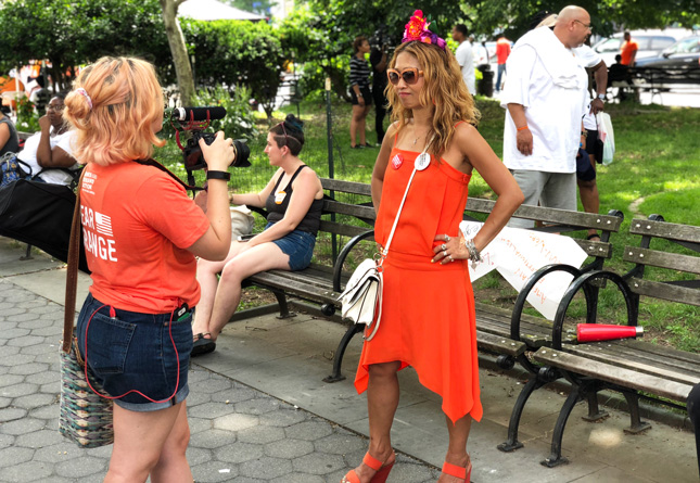 Student films a woman during a march against gun violence