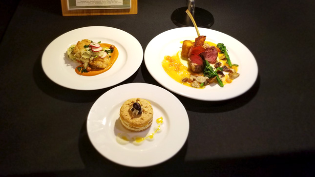 An arrangement of plated dinner and desserts 