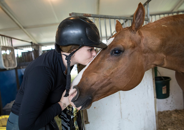 Girl kisses her horse