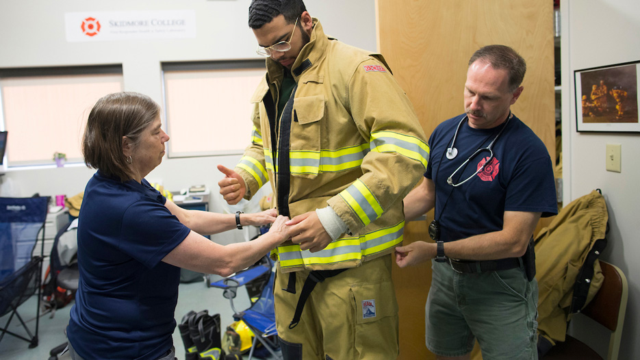 A first responder tries on new firefighting gear