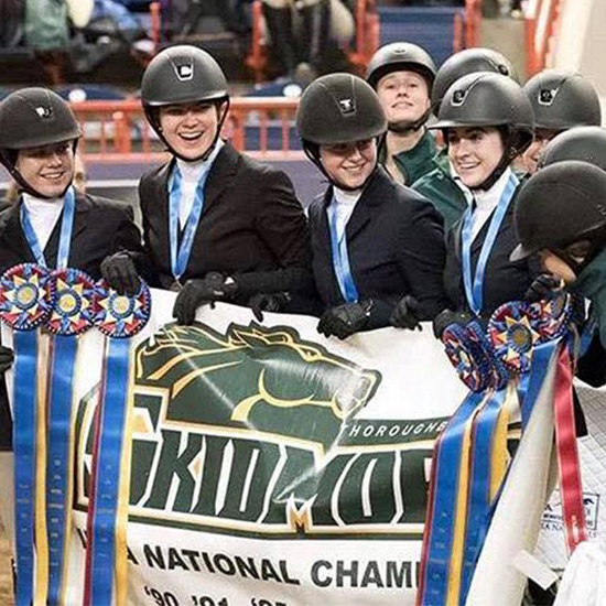 Members+of+a+riding+team+celebrate+a+national+championship+with+their+ribbons+