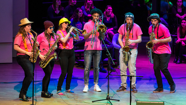 Skidmore students performing on stage for a Beatles tribute concert