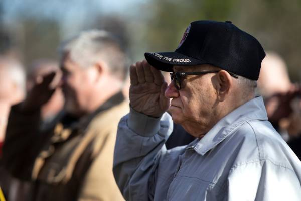 A veteran salutes the flag.