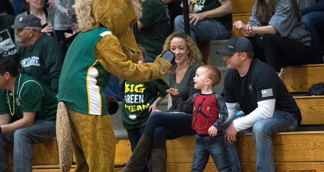 Skidmore's mascot gives a high five to a young fan
