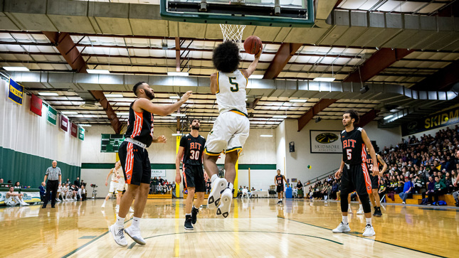 Skidmore basketball player jumps for a layup during a game