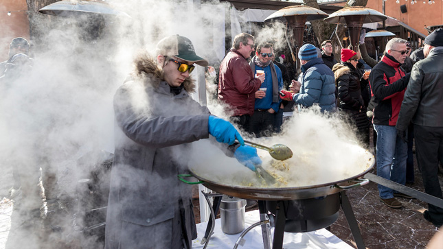 Steam rising off a large pot of chowder 