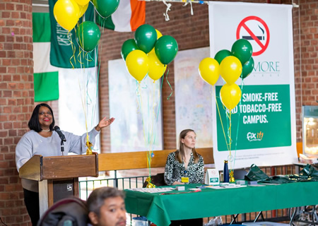 Cerri Banks, dean of students and vice president for student affairs, speaks at a launch event for Skidmore’s new smoke-free, tobacco-free initiative. Seated is Shannon Morrison-Gaczol, program coordinator for the Living Tobacco-Free Initiative at the Health Promotion Center of Glens Falls Hospital, which is partnering with Skidmore. 