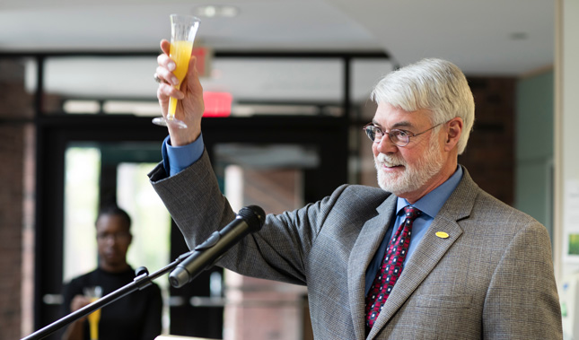 President Glotzbach holding champagne for a toast