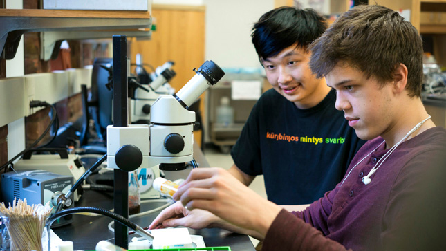Skidmore College students use microscopes in a lab