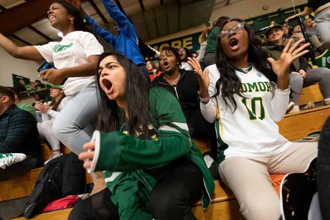 Fans yell during a basketball game at Skidmore College