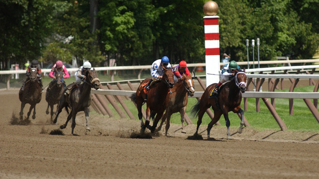 Horses running at a race track