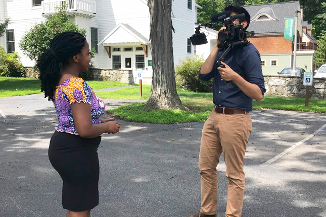 A student is filmed by a videographer during an internship