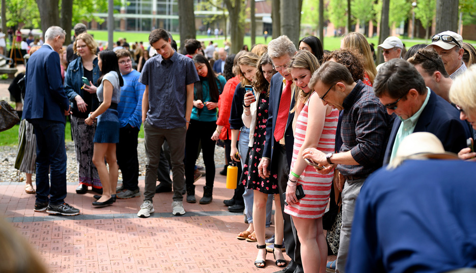 Group of seniors and parents look over the new bricks