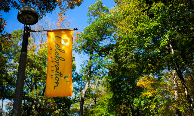 A banner that says "Celebration Weekend" hangs over Skidmore College campus