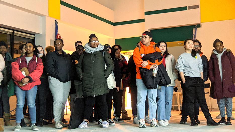 Students tour the space that will house the new center. 