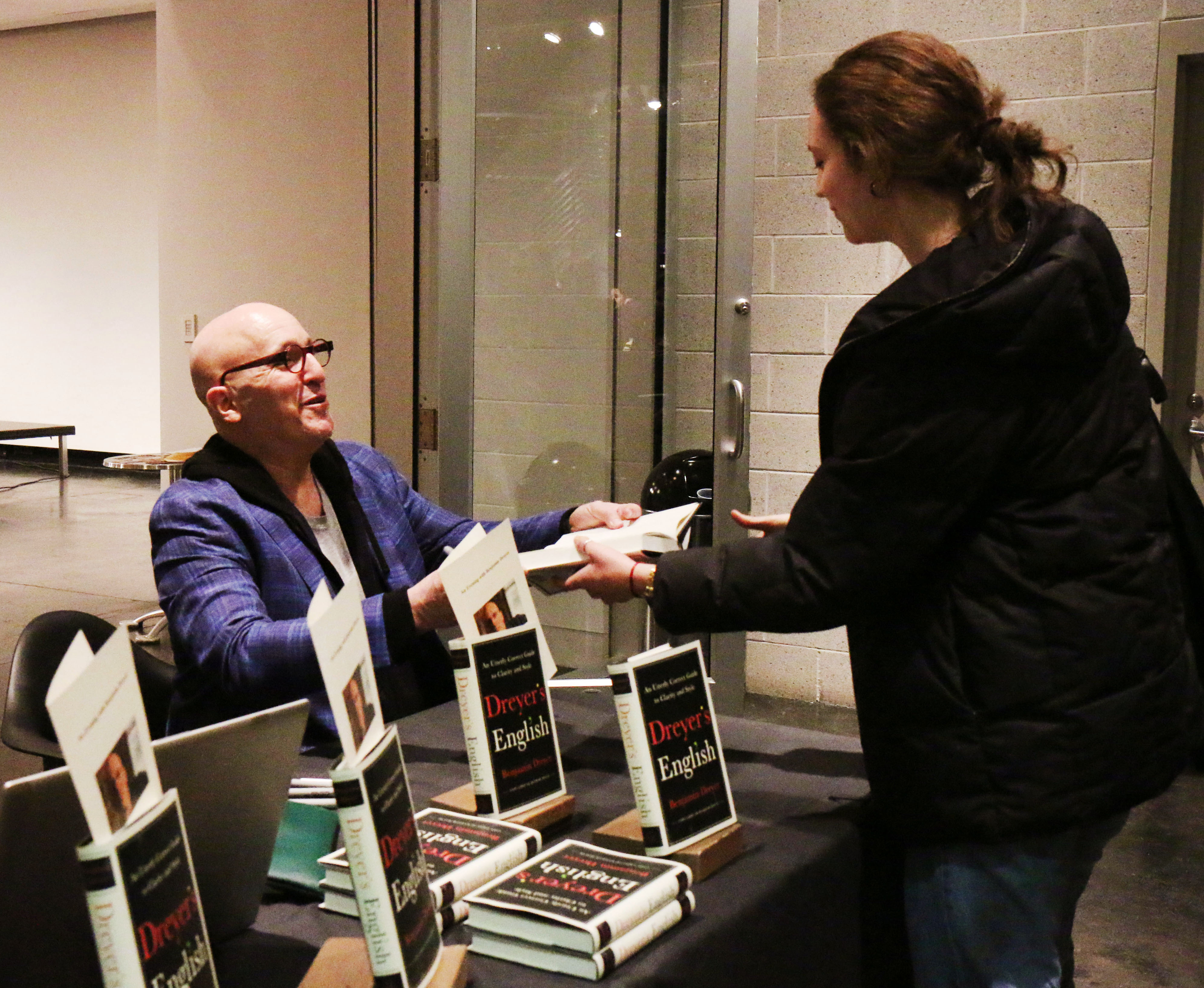 Dreyer signs copies of his book for students