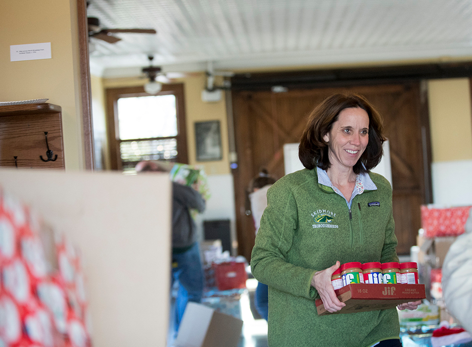 Associate Athletic Director Megan Buchanan carries food donated as part of Skidmore Cares in 2018.