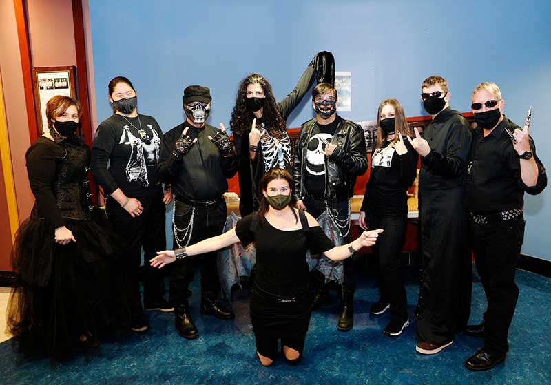 Dining services staff pose for photo in gothic halloween costumes