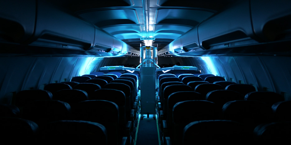 The Dimer GermFalcon disinfects the interior of an airplane with UVC light.
