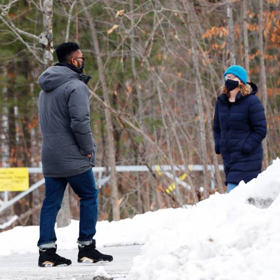 Two+students+walk+across+campus.