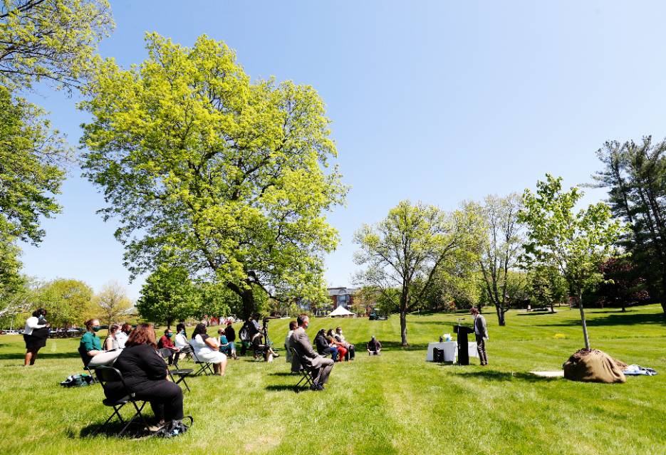 Assistant Professor of English Nicholas Junkerman speaks at a tree planting in memory of Samantha Sasenarine ’21. 