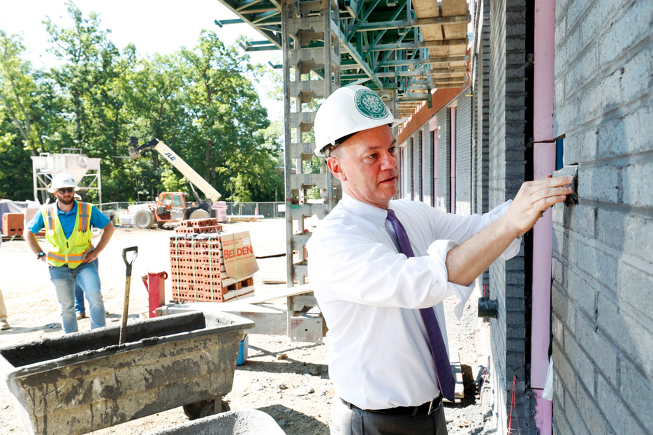 President Marc Conner places East Wing brick