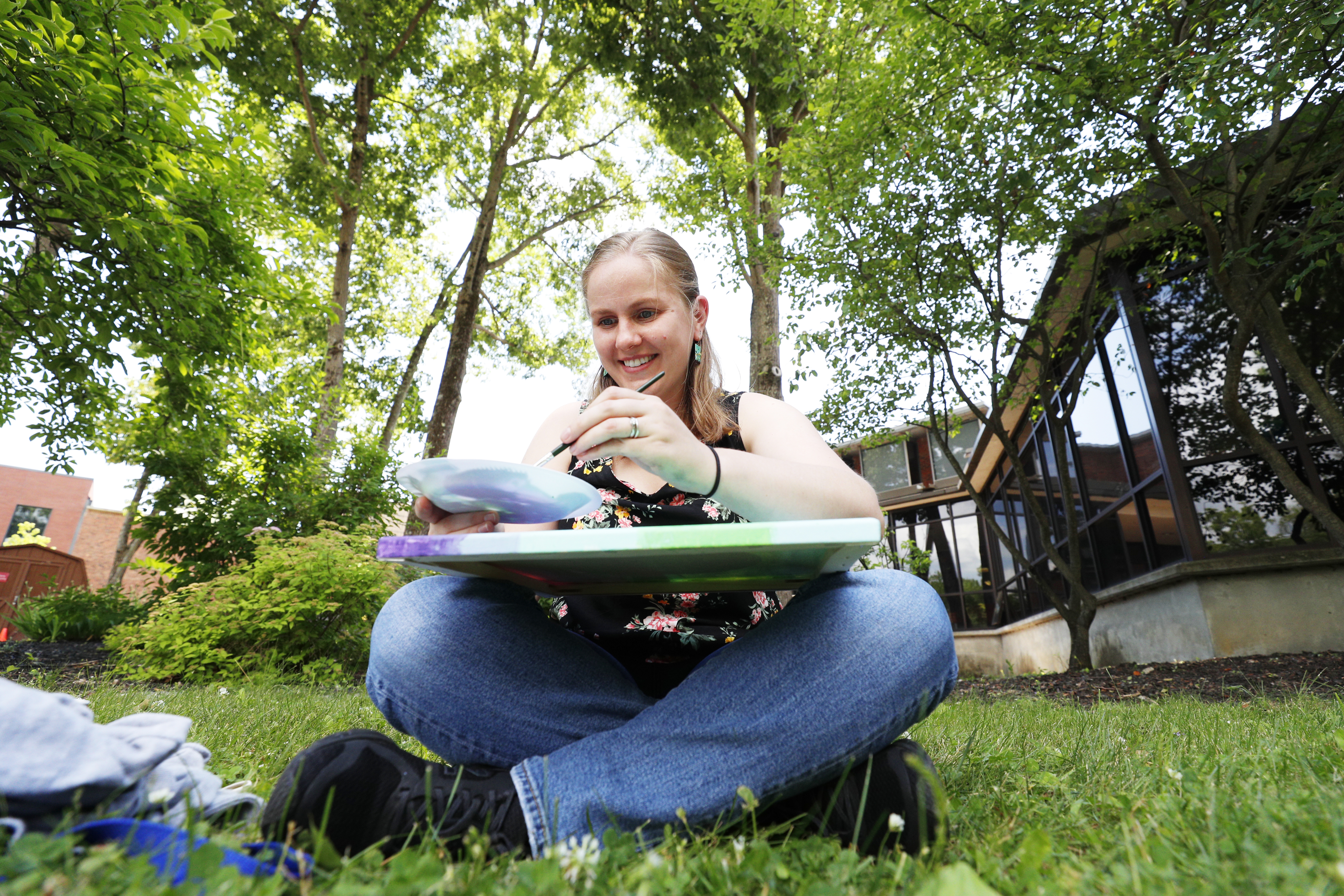 Anna Brezny, assistant professor of chemistry, participates in an outdoor painting class with faculty, staff, and students that is directed by her colleague, Senior Instructor of Chemistry Beatrice Kendall.
