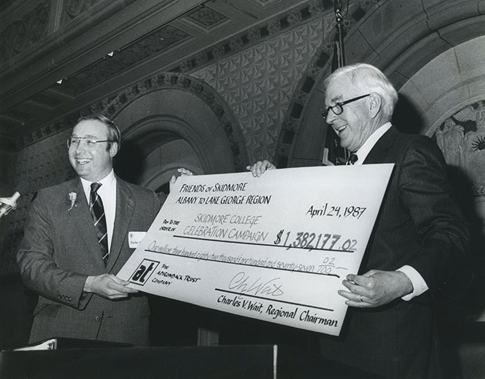 President Palamountain receives a check from Charles Wait Jr.