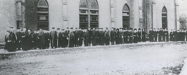 The academic processional for the Oct. 26, 1912, inauguration of Skidmore’s first president, Charles Henry Keyes, makes its way around the old campus in downtown Saratoga Springs. (Bolster Collection)