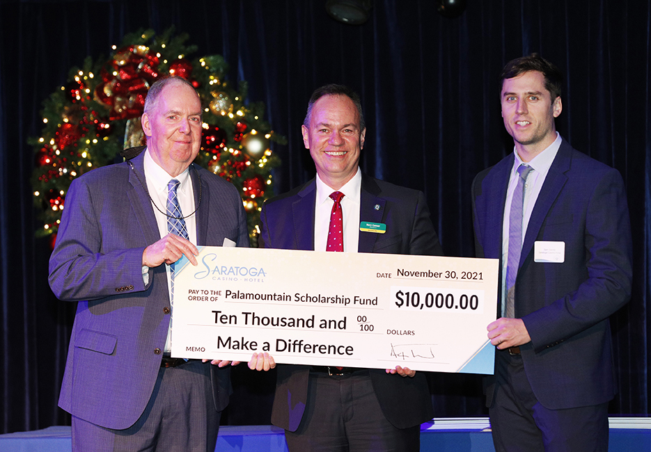  Skidmore College President Marc Conner, center, accepts the gift from Saratoga Casino Vice President of External Affairs Skip Carlson, left, and Vice President of Business Development Sam Gerrity. 