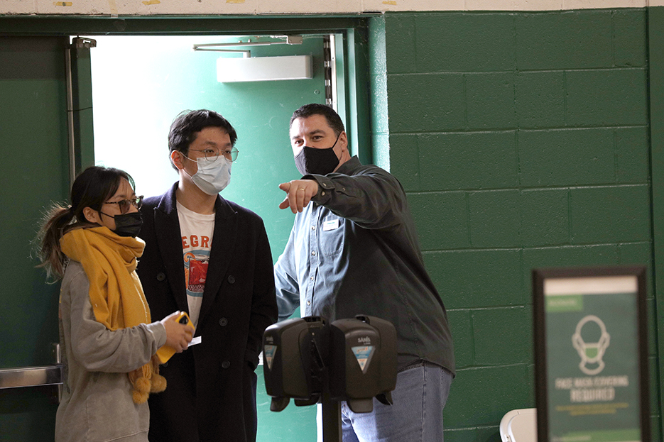 Andrew Demaree, director of Skidmore's Counseling Center, directs students at the vaccination clinic. 