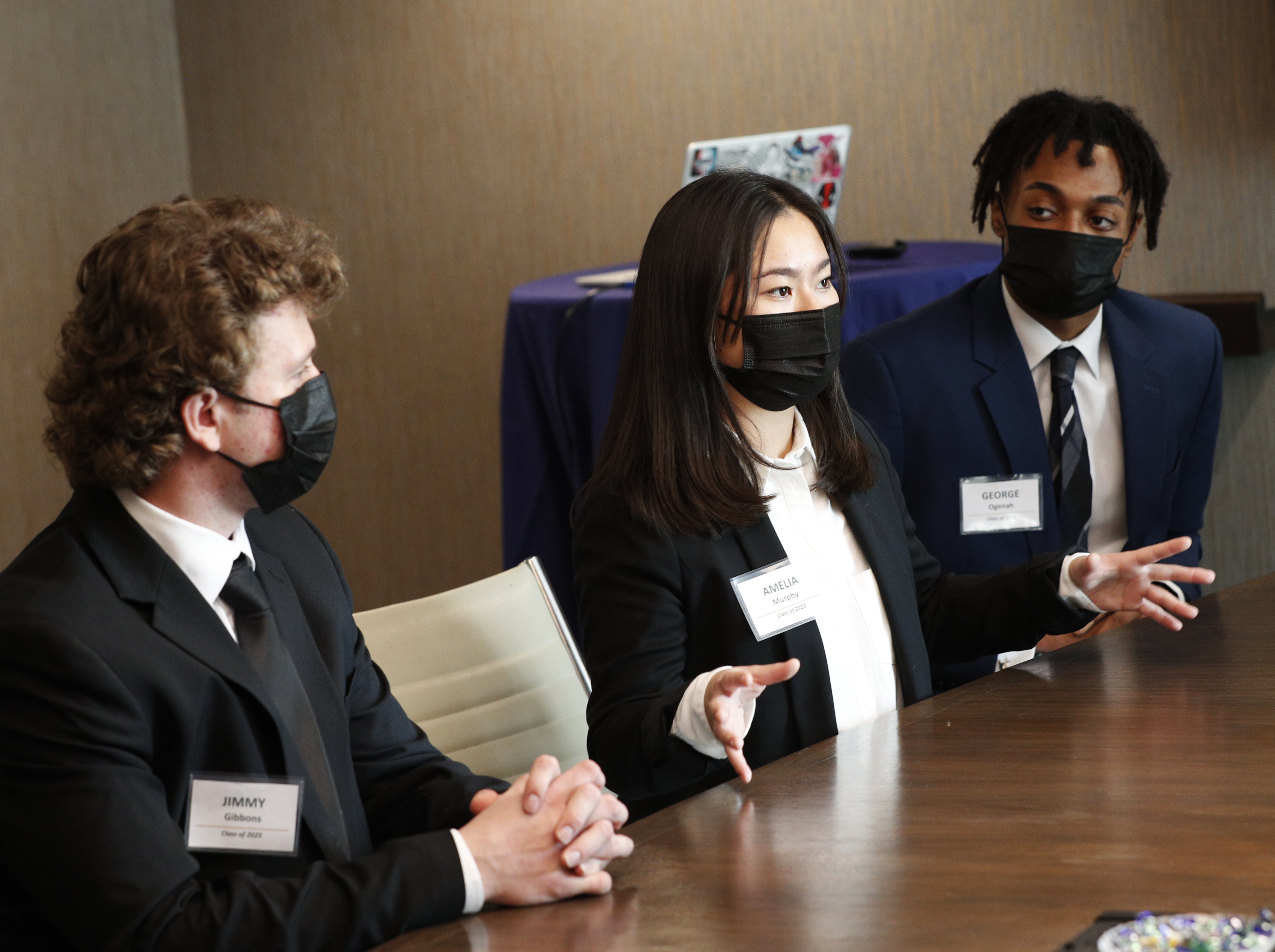 Amelia Murphy ’23, center, speaks during an executive presentation. Also shown are Jimmy Gibbons’ 25, left, and George Ogenah ’24.