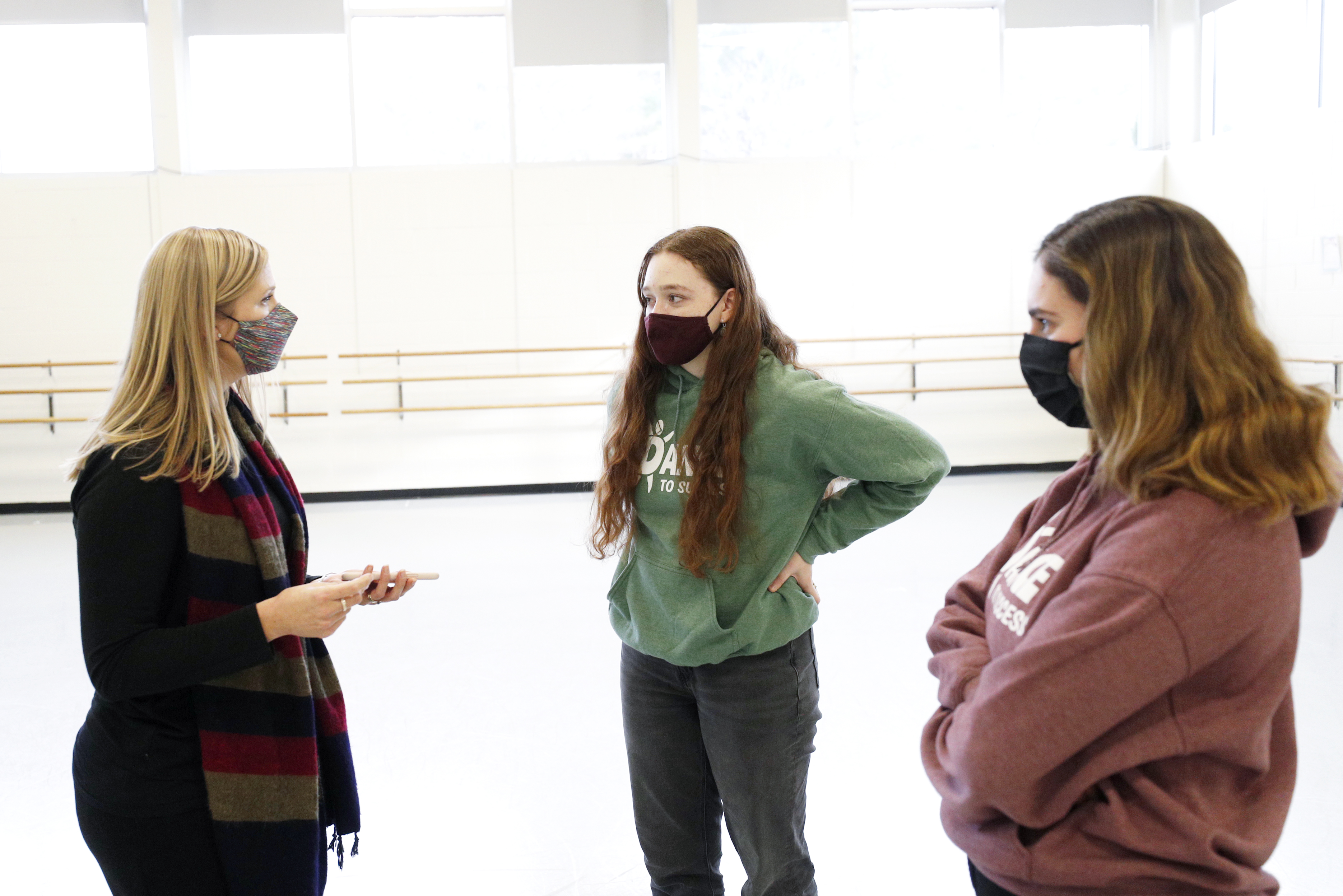  From left, Sarah DiPasquale, associate professor and chair of the Dance Department, speaks with Amanda Francis ’25 and Julianna Willis ’22.
