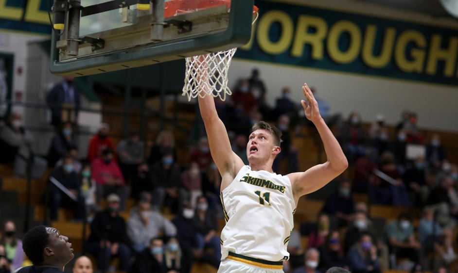 male basketball player jumps for a layup at the hoop