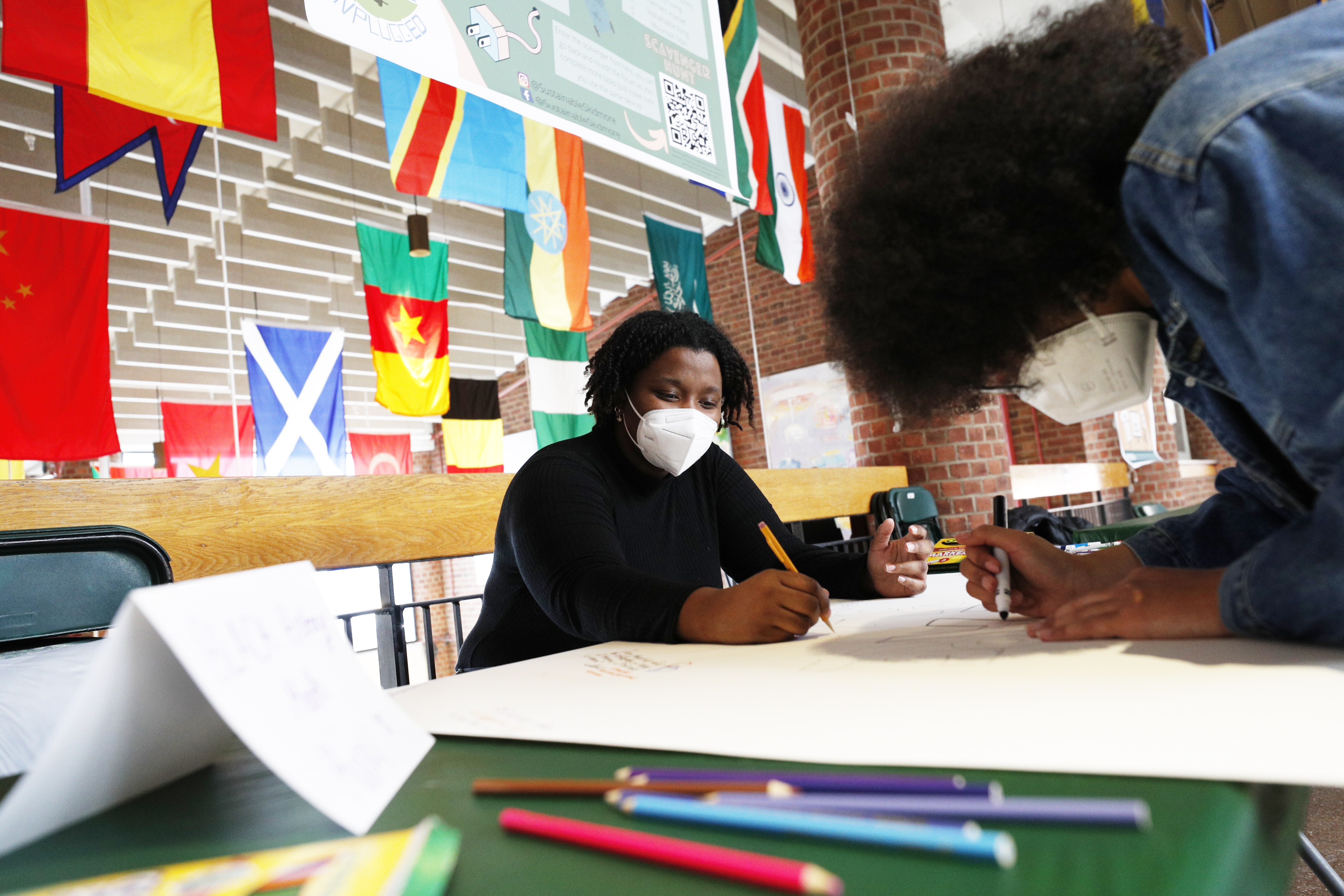 Anissa Joseph '22, left, and Luna Peralta '23 contribute to a mural marking Black History Month in Case Center. The activity was sponsored by UJIMA, a student club that works to bring awareness of African, African American, and Caribbean cultures to the Skidmore campus and broader community. 