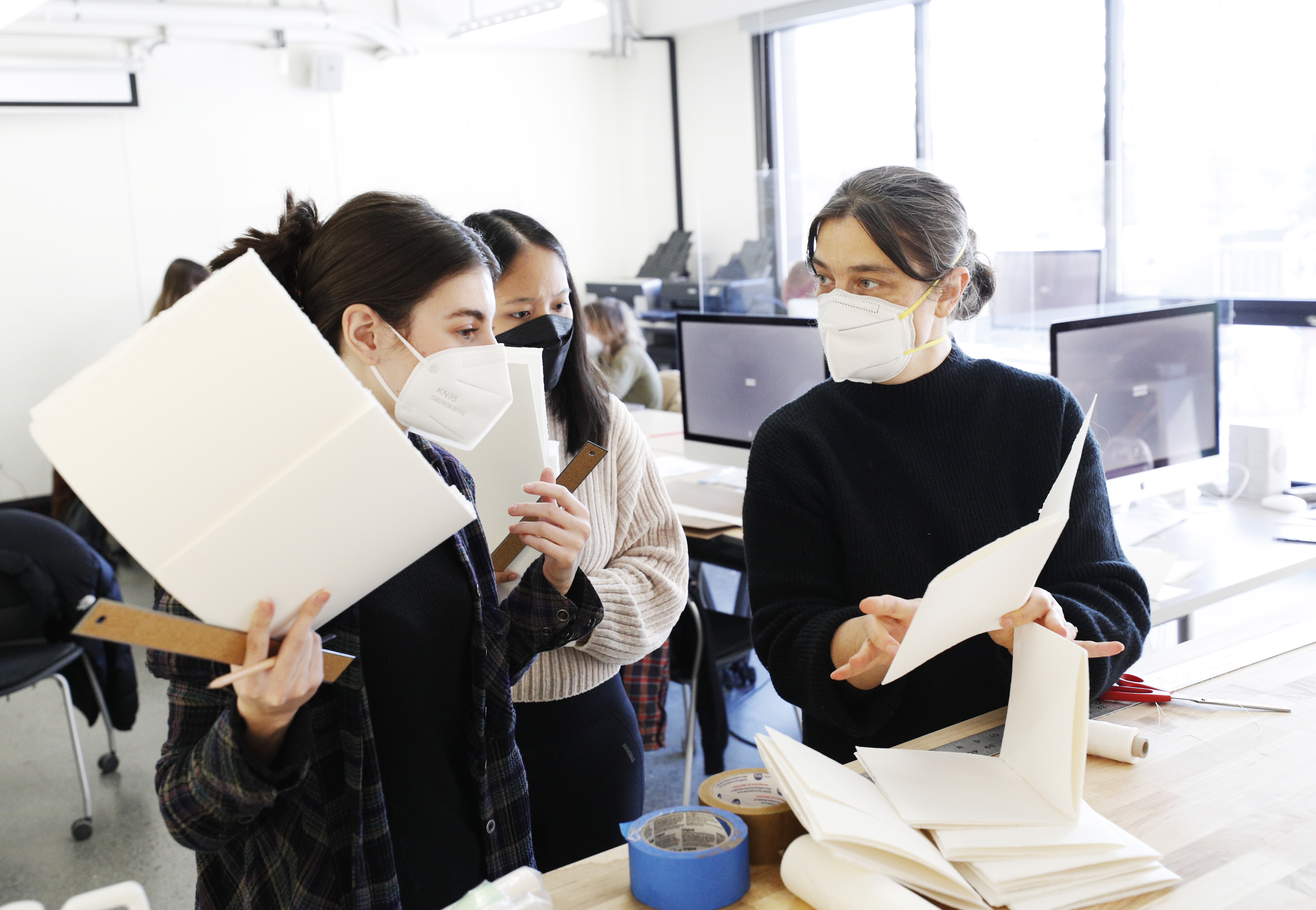 Abby Flatau ’22 and Pema Gyalpo ’22 talk with Professor of Art Sarah Sweeney during Sweeney’s Expanding the Artist Notebook course. 