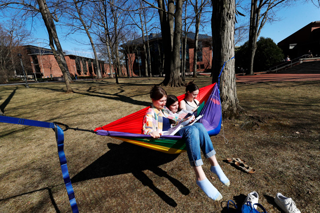 Students sit in a hammock