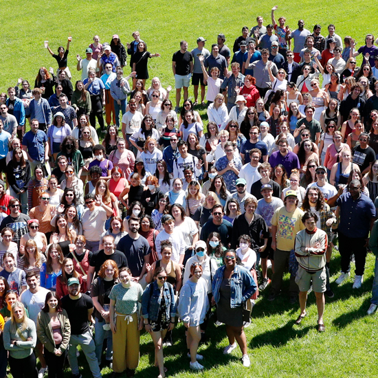 A+crowd+of+over+500+college+students+stand+in+a+grassy+field