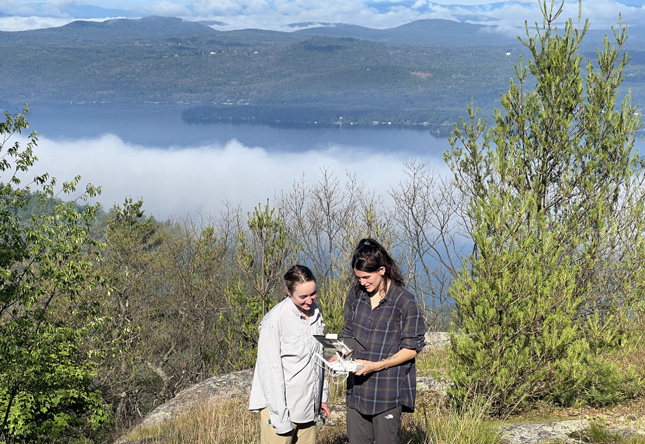 Morgan Foster '23 and Avery Blake '23 fly a drone in Lake George Watershed