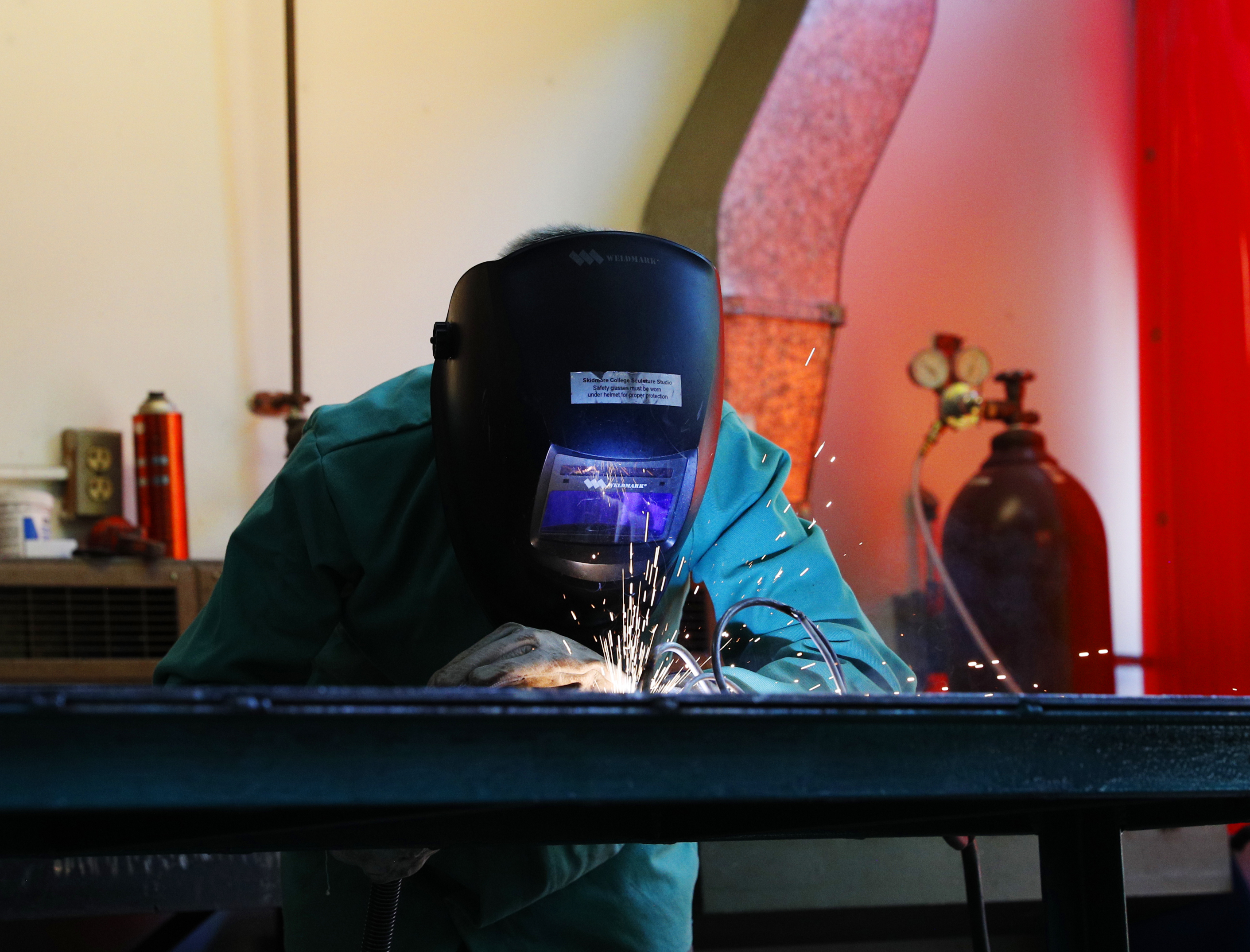 A student welding during a summer course