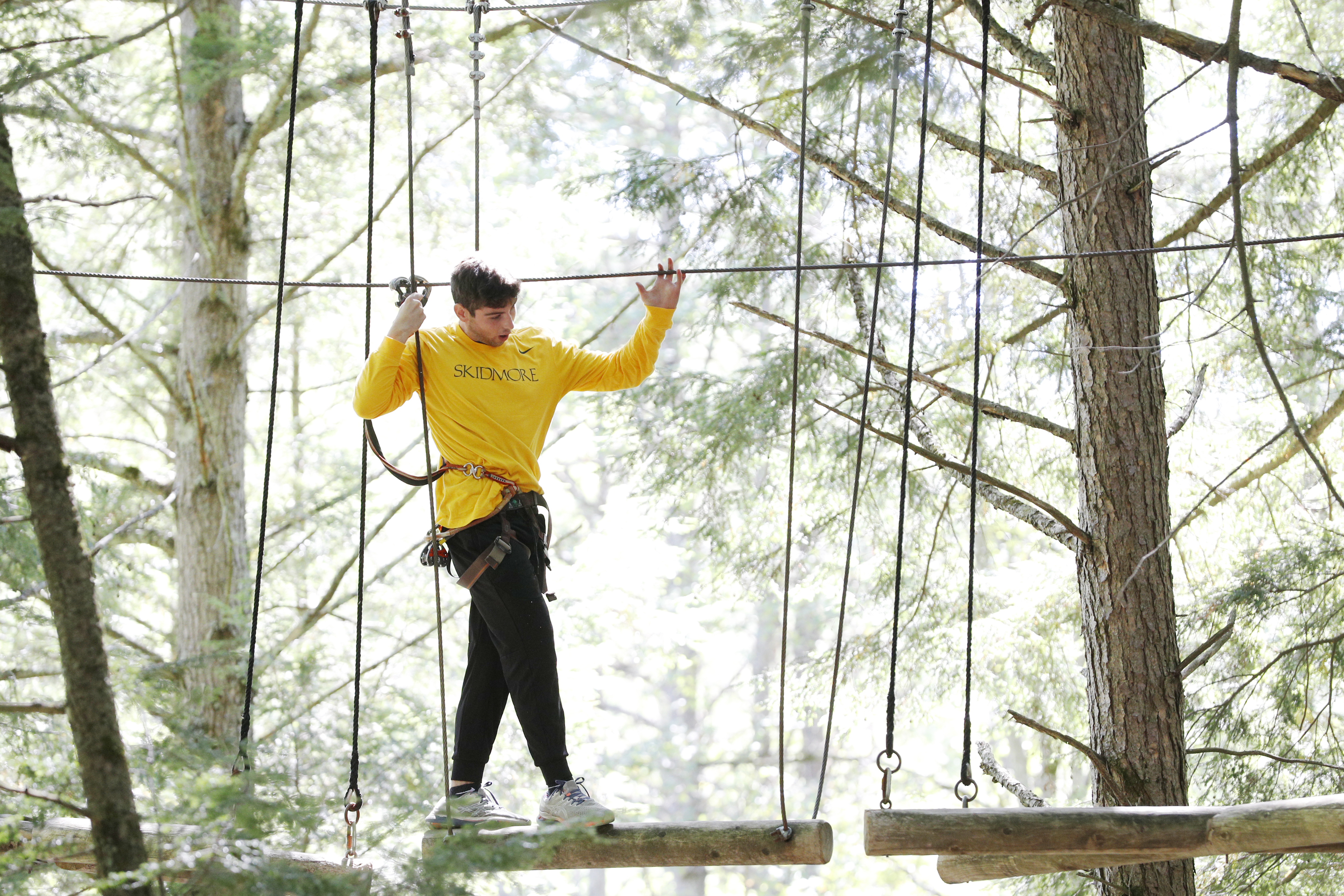 A Skidmore student participates in a ropes course as part of pre-orientation programming before the start of classes. 