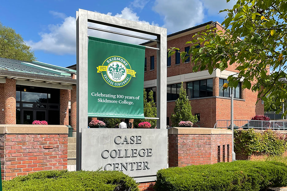 A banner featuring Skidmore's College Centennial outside Case Center