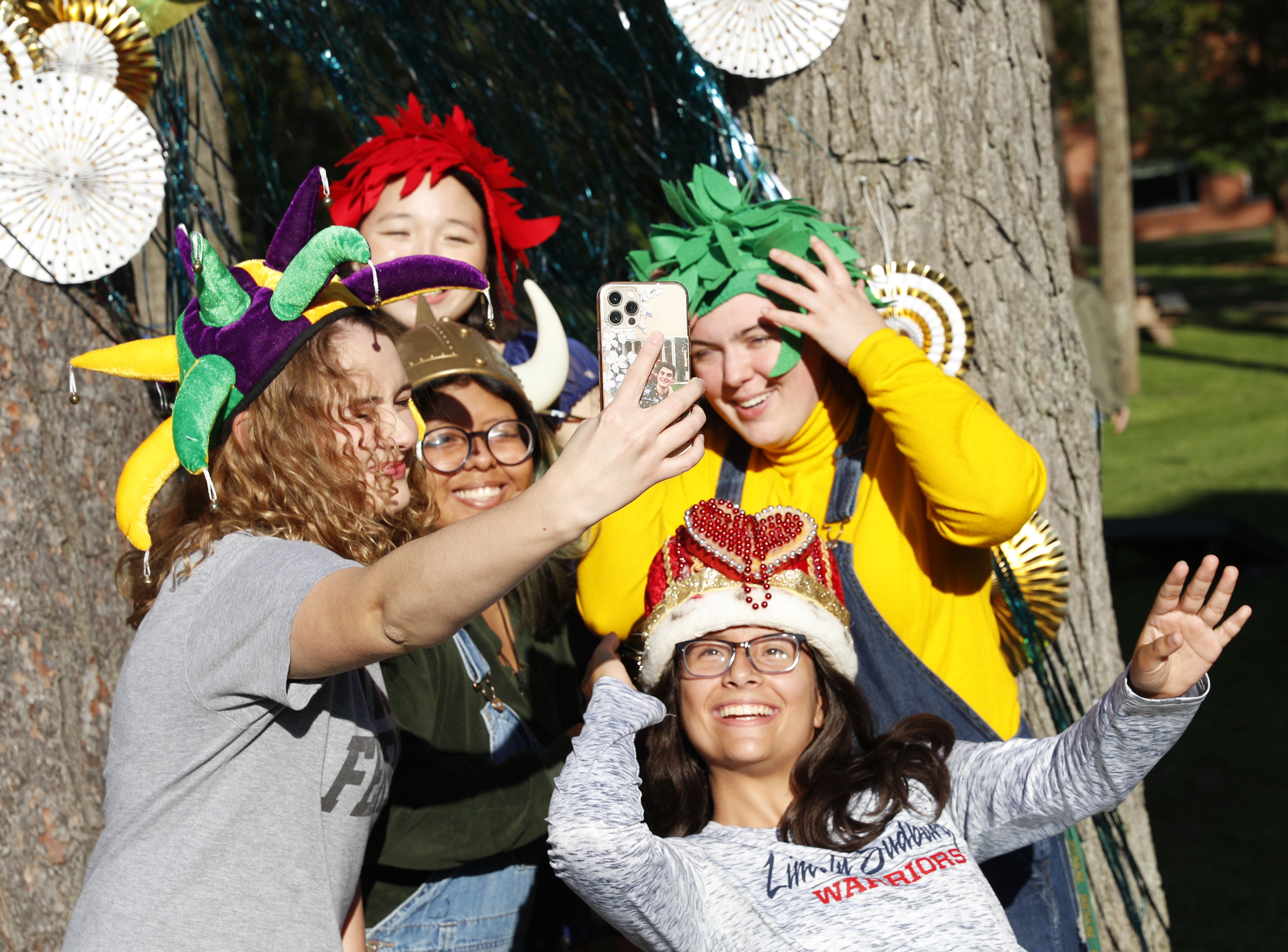 student take a selfie while wearing costume hats