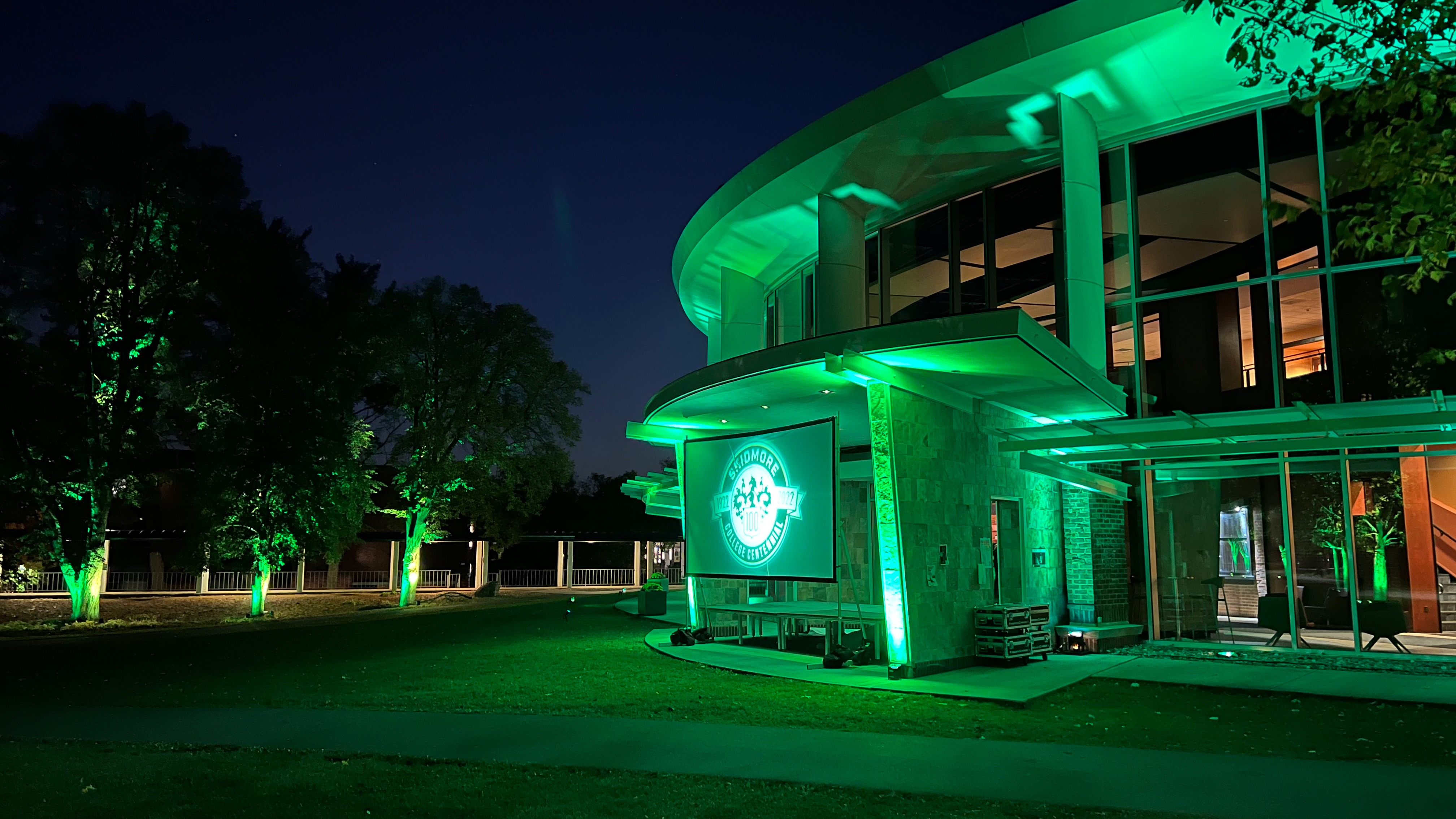 The Murray-Aikins Dining Hall glowing in green 