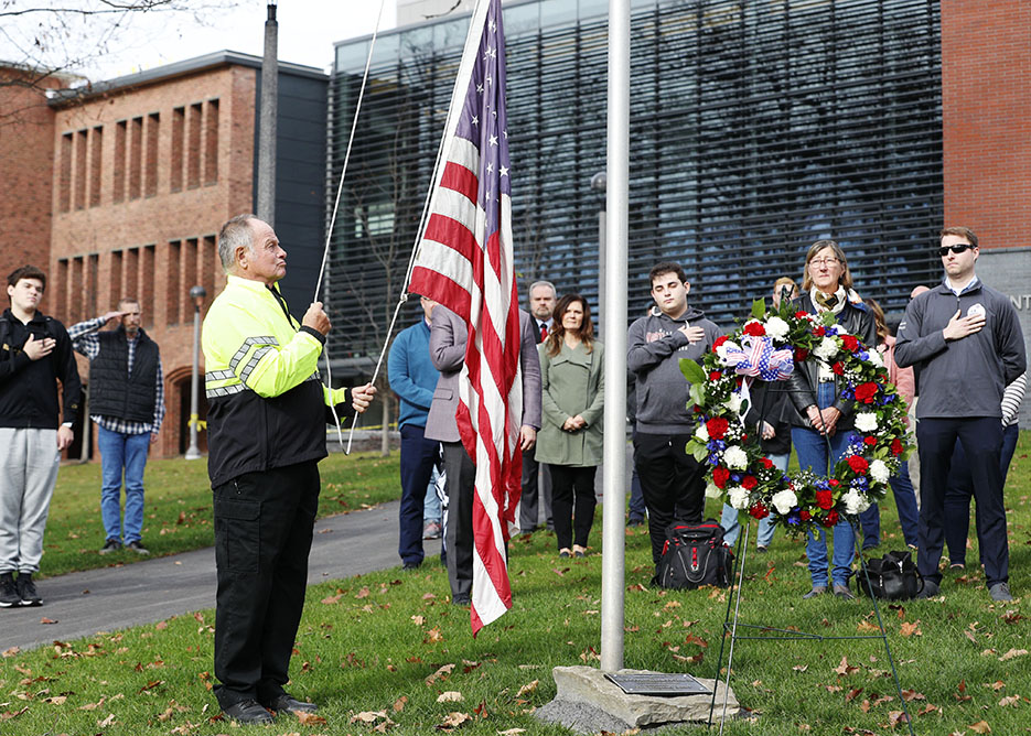 Campus Safety Officer Raymond Apholz raises the American flag at a campus Veterans Day ceremony on Friday, Nov. 11. 