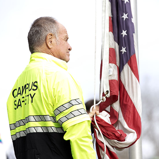 A+Campus+Safety+officer+with+the+American+flag